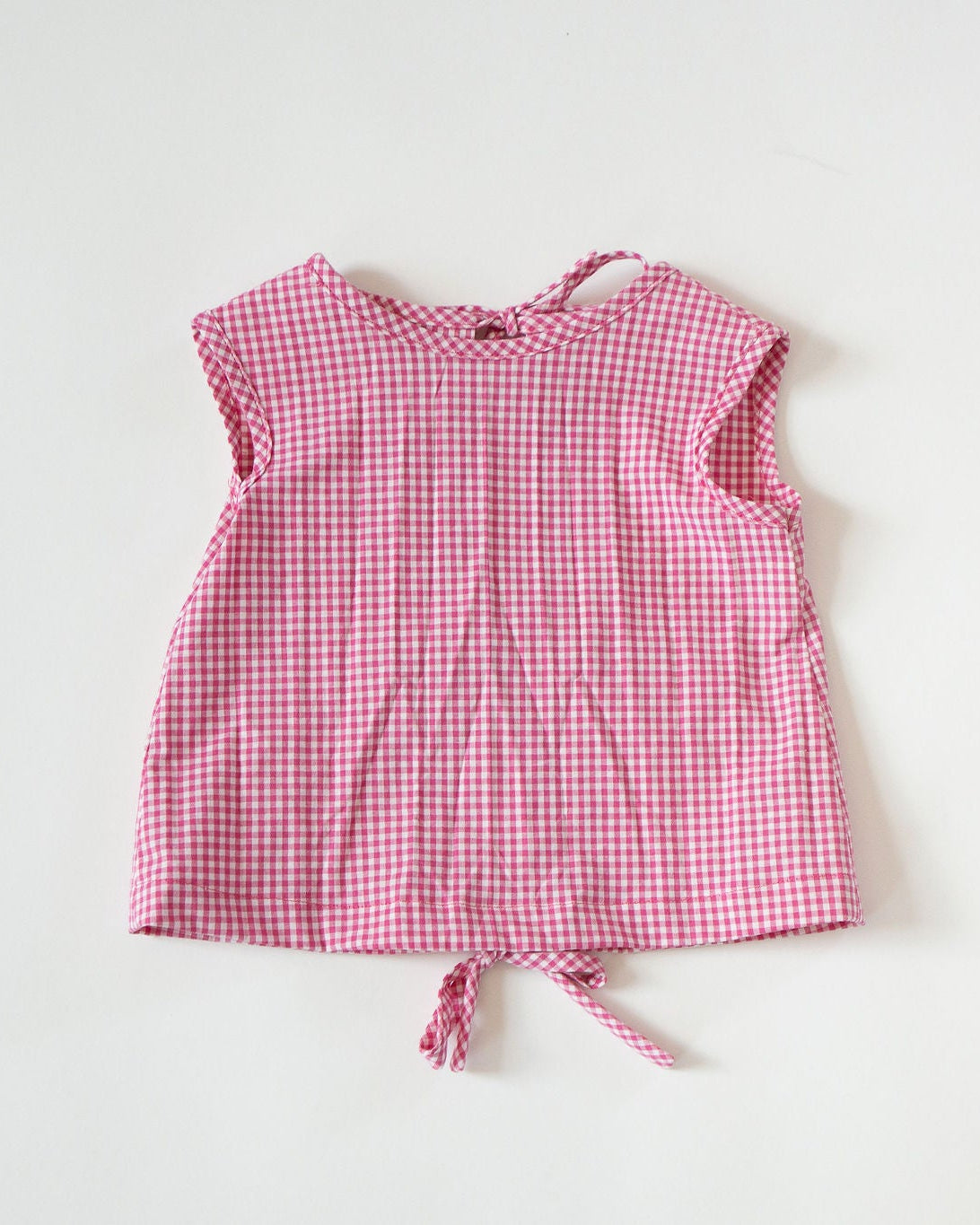 Pink checkered dress on a white background