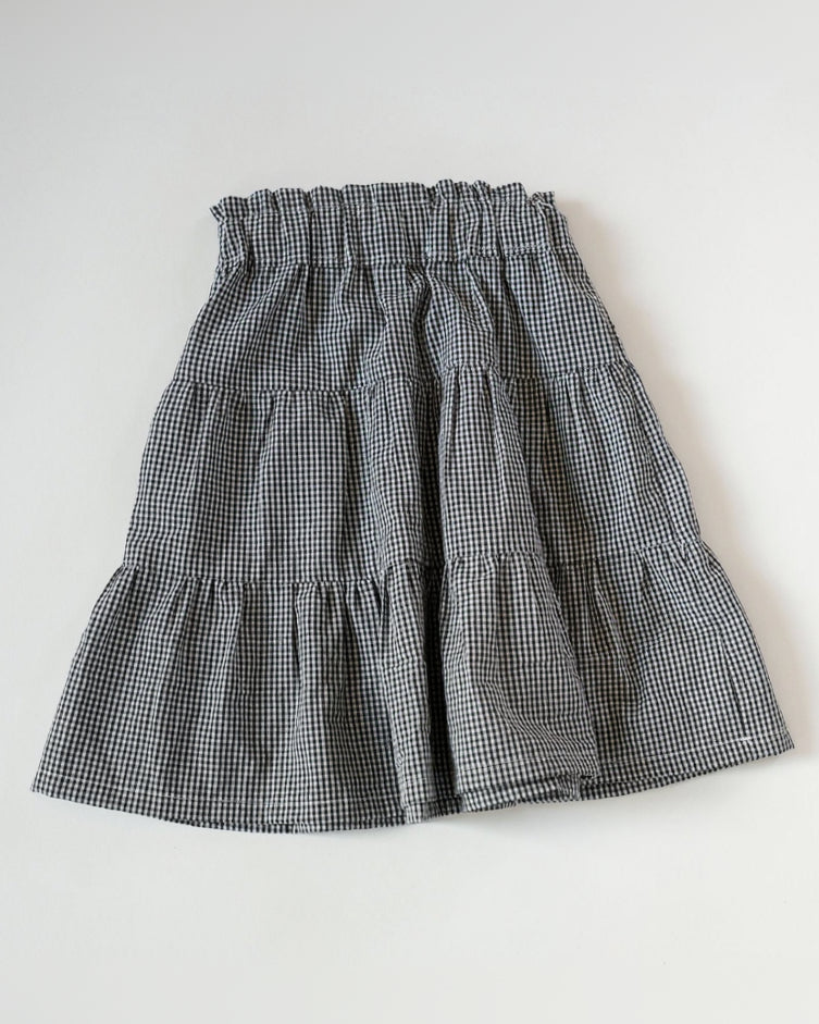 Black and white checkered skirt on a light gray background