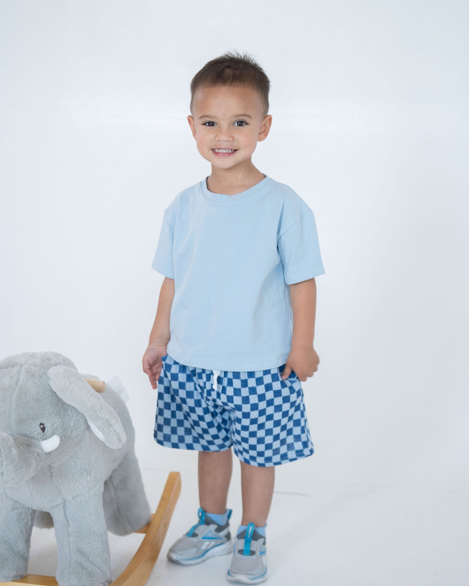 Blue and white checkered shorts on a light gray background