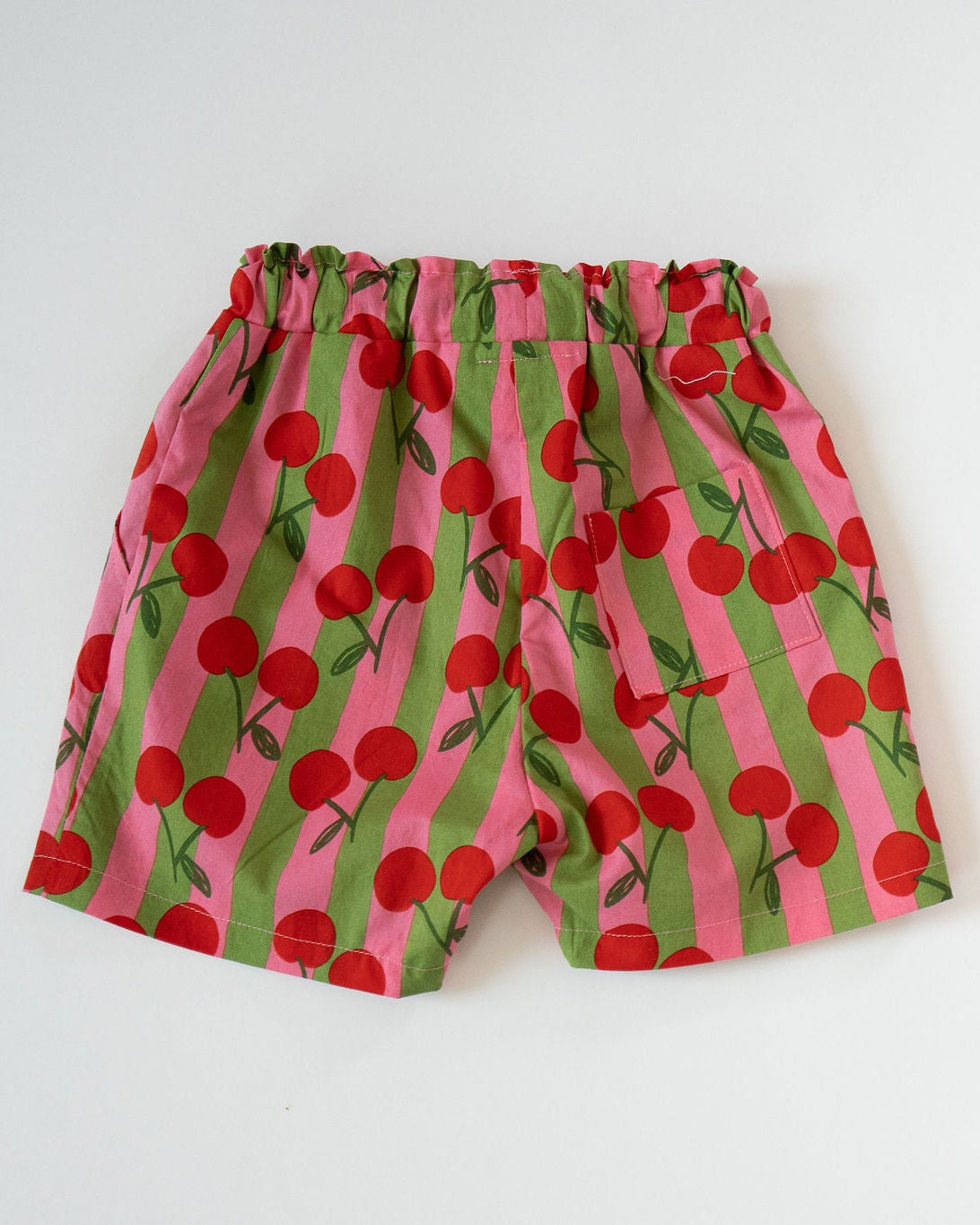 Children's shorts with cherry pattern on a white background