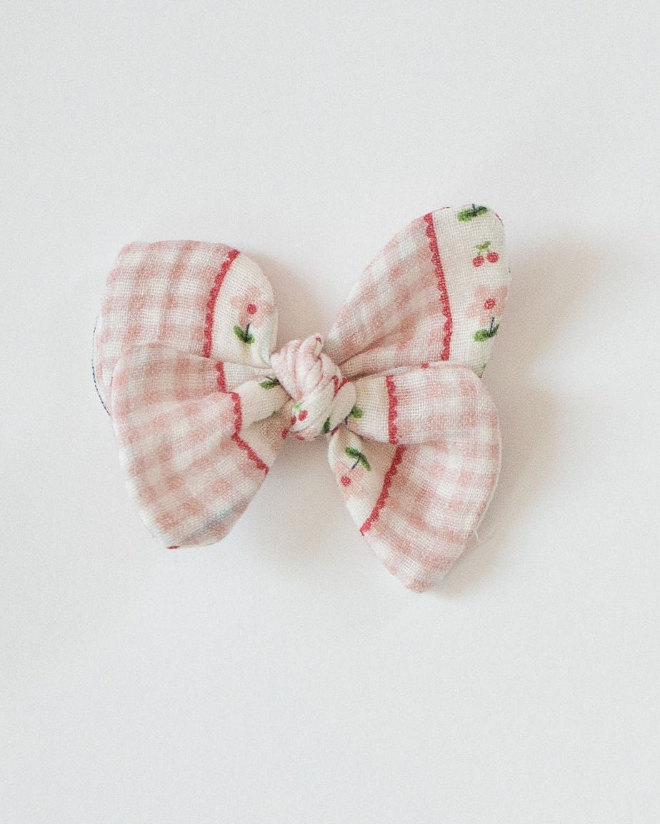 Plaid bow hair accessory on a white background