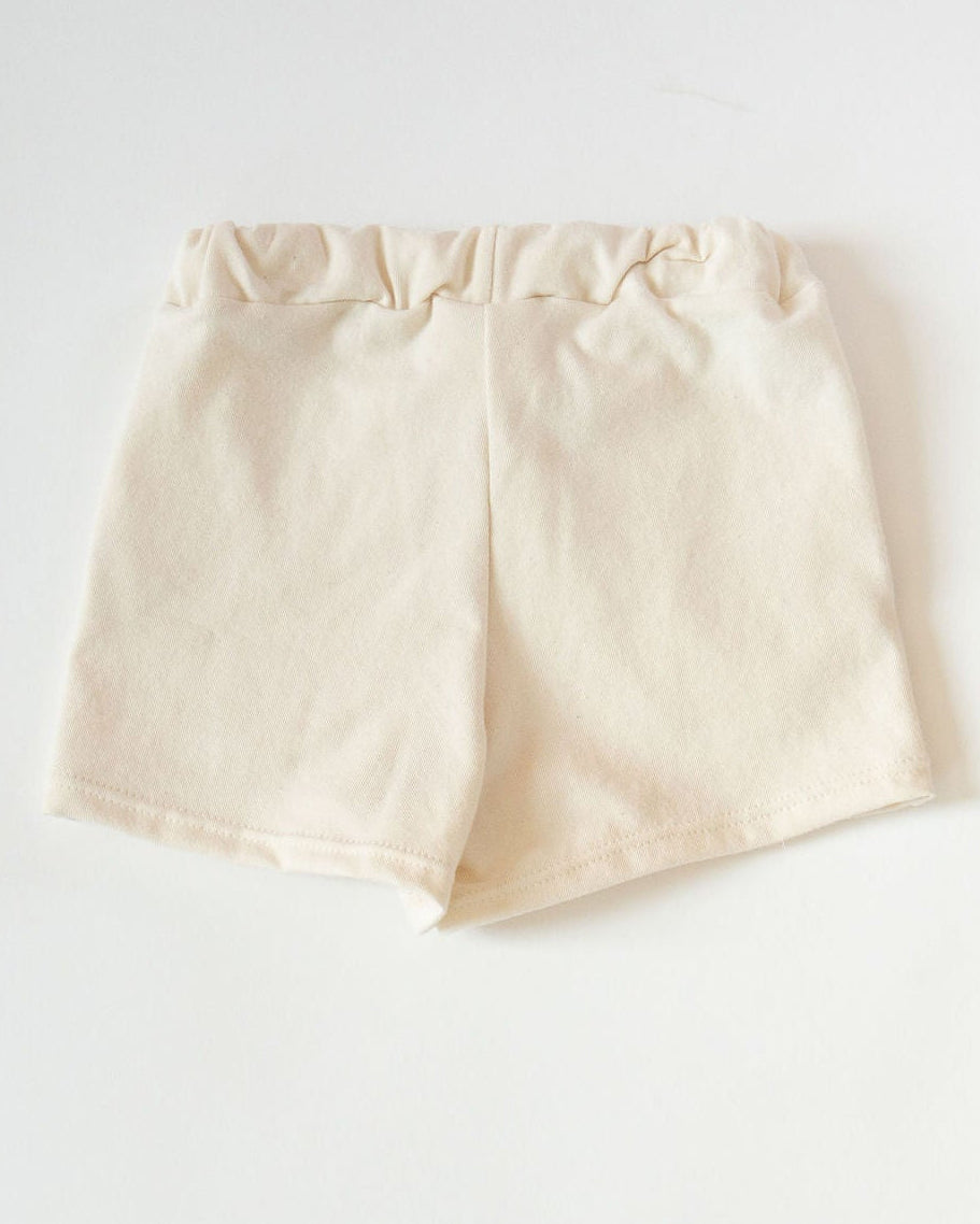 Cream shorts on a white background