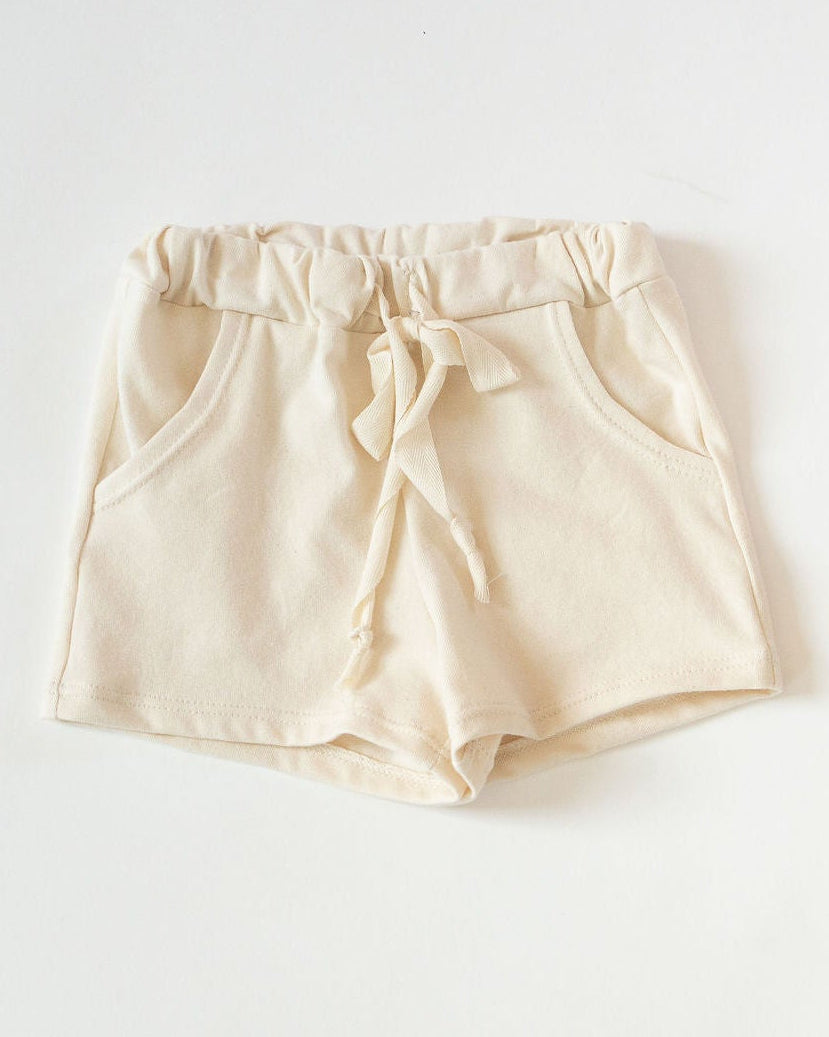 Cream shorts on a white background