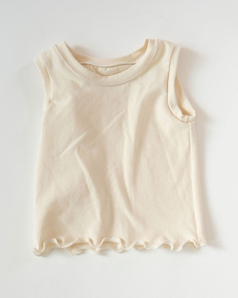 Beige tank top on a light gray background