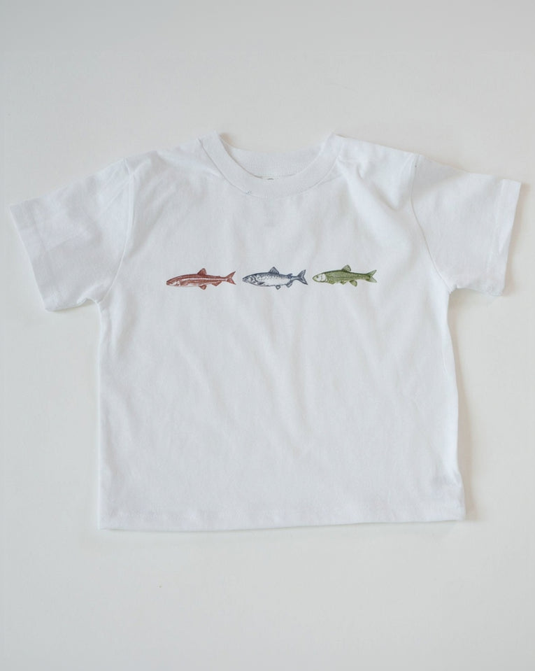White t-shirt with fish illustrations on a light gray background