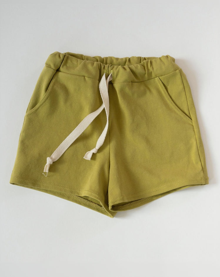 Green shorts with a drawstring on a white background