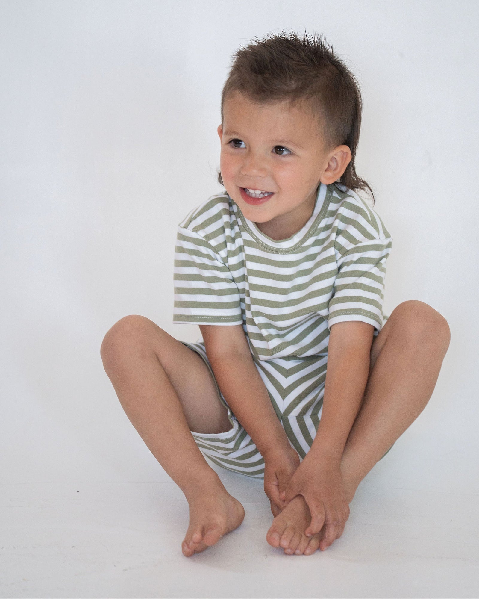 Green and white striped t-shirt on a light gray background