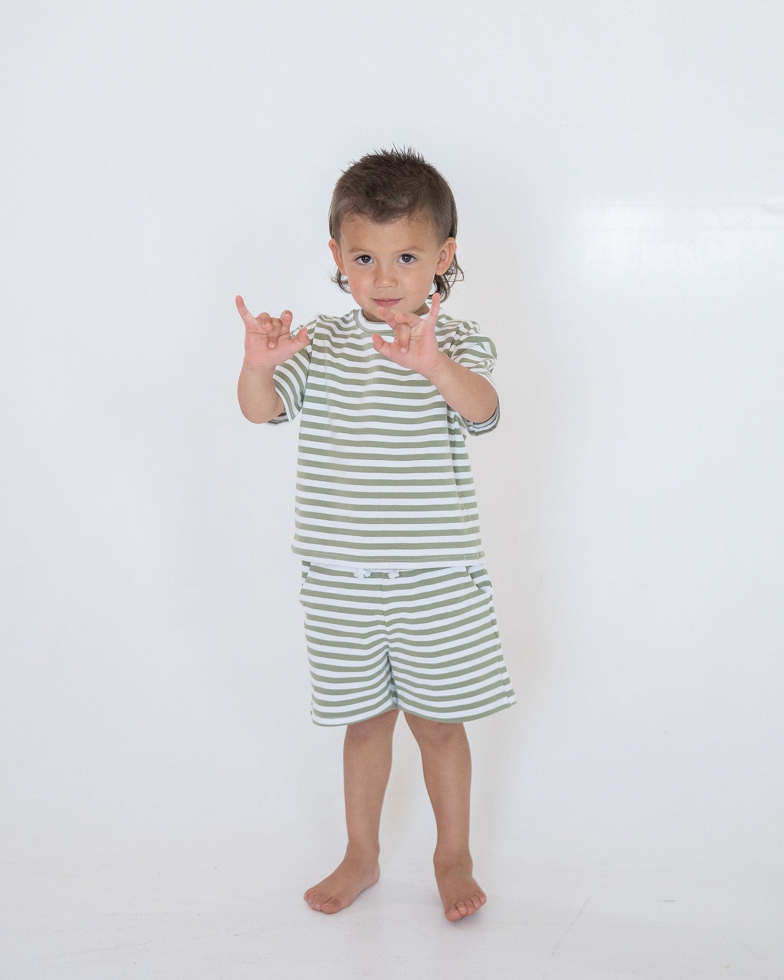 Green and white striped shorts on a light gray background