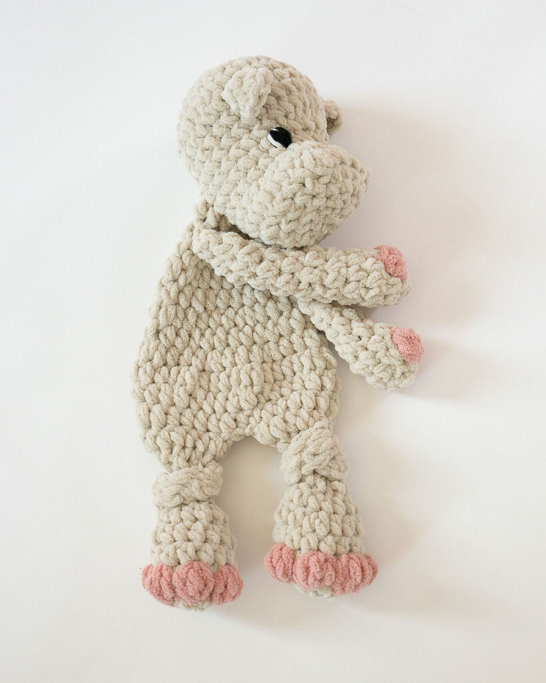 Knitted toy hippo on a white background