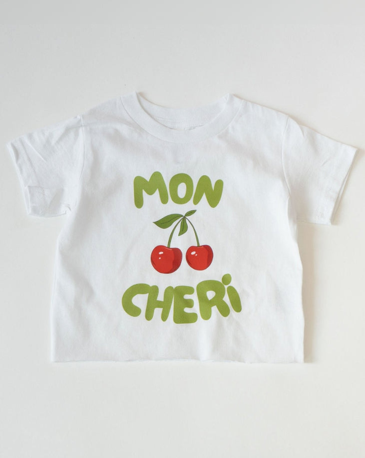White t-shirt with 'MON CHERI' and cherries design on a white background