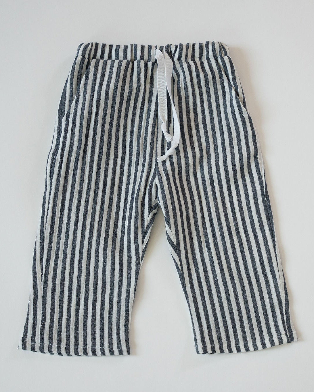 Striped pants with a drawstring on a light gray background