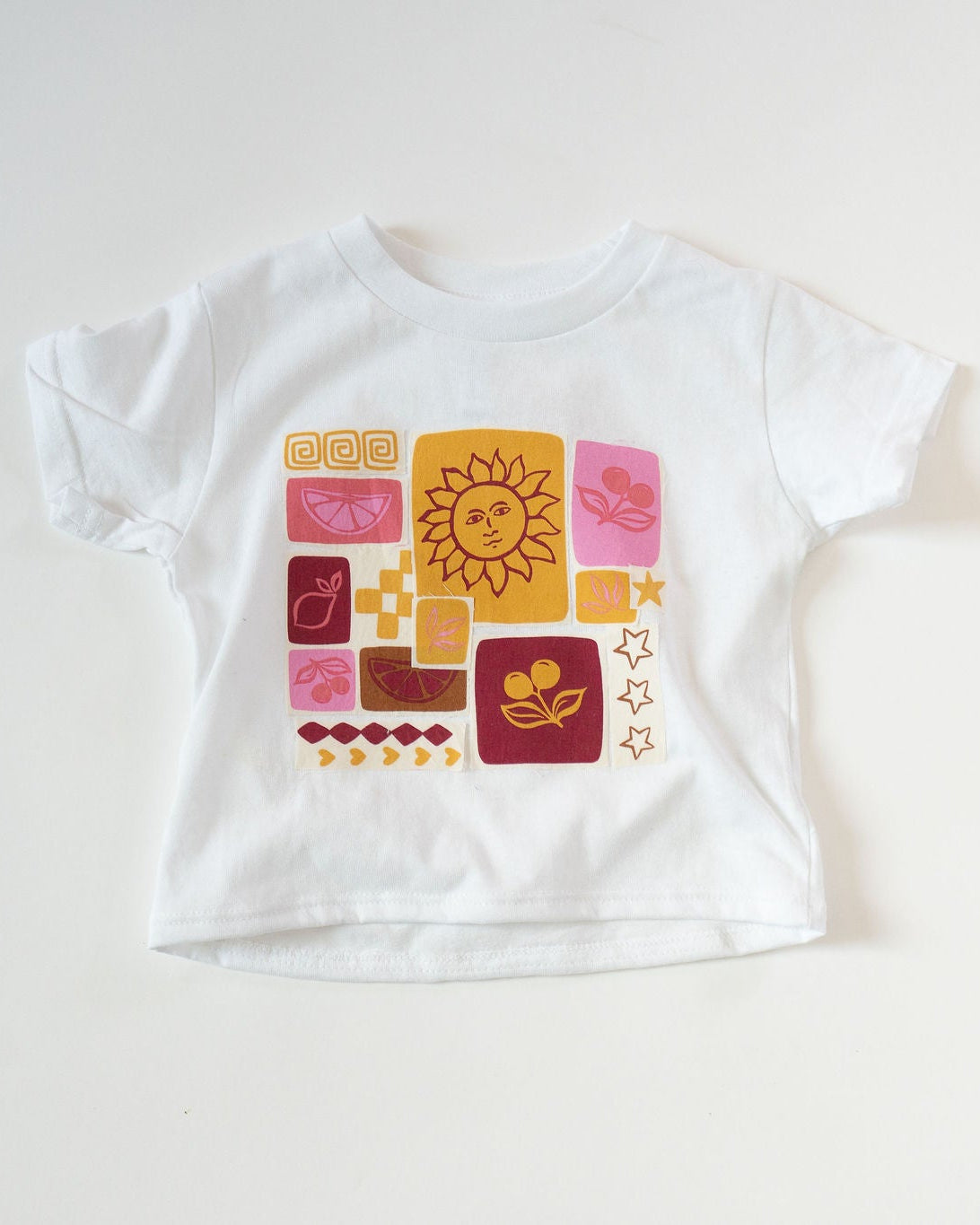 White t-shirt with colorful graphic design on a white background