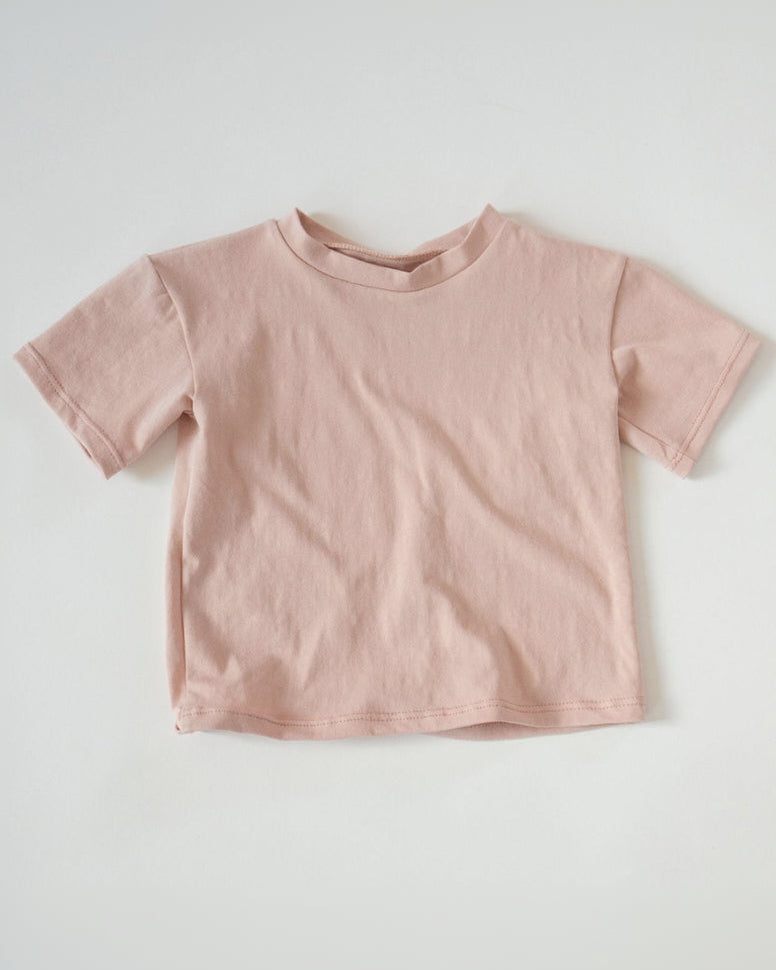 Pink t-shirt on a light gray background