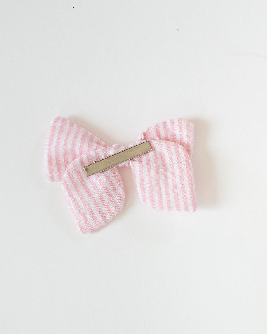 Pink checkered bow on a white background