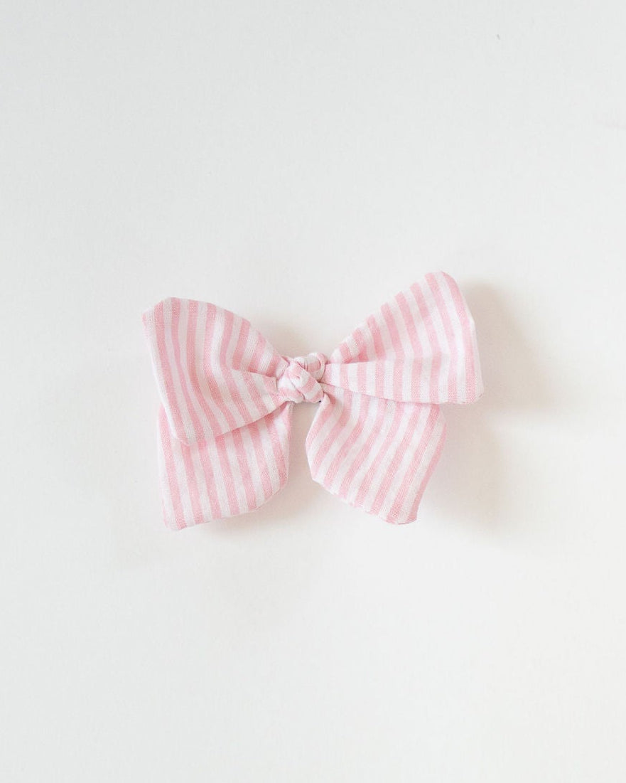 Pink checkered bow on a white background
