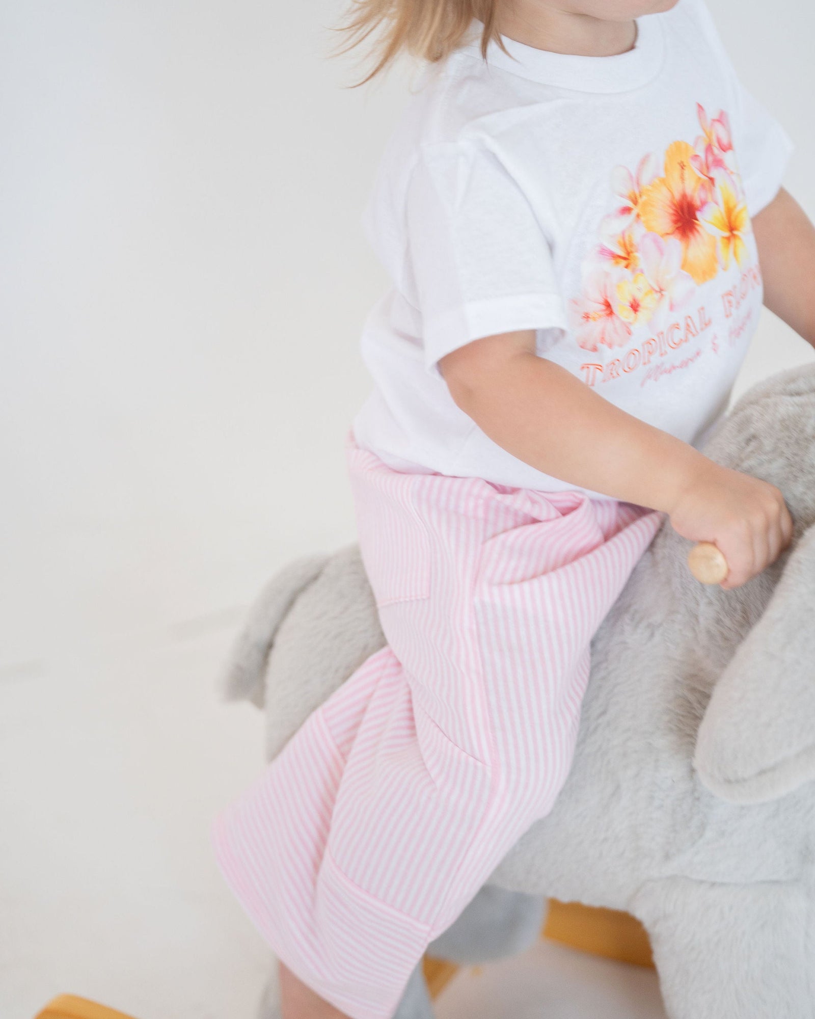 Pink striped pants on a light gray background
