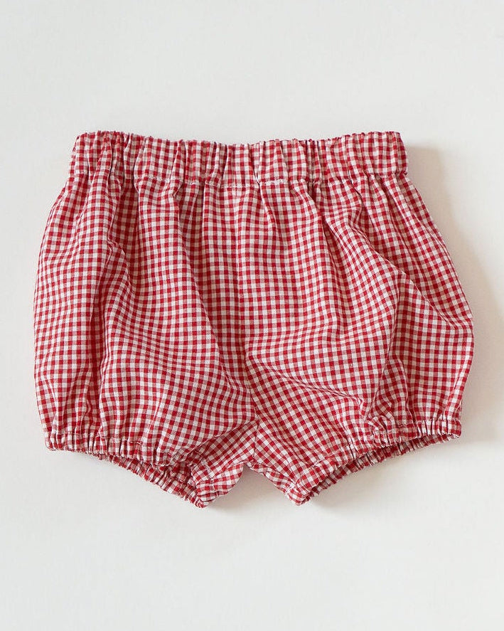 Red checkered baby bloomers on a white background