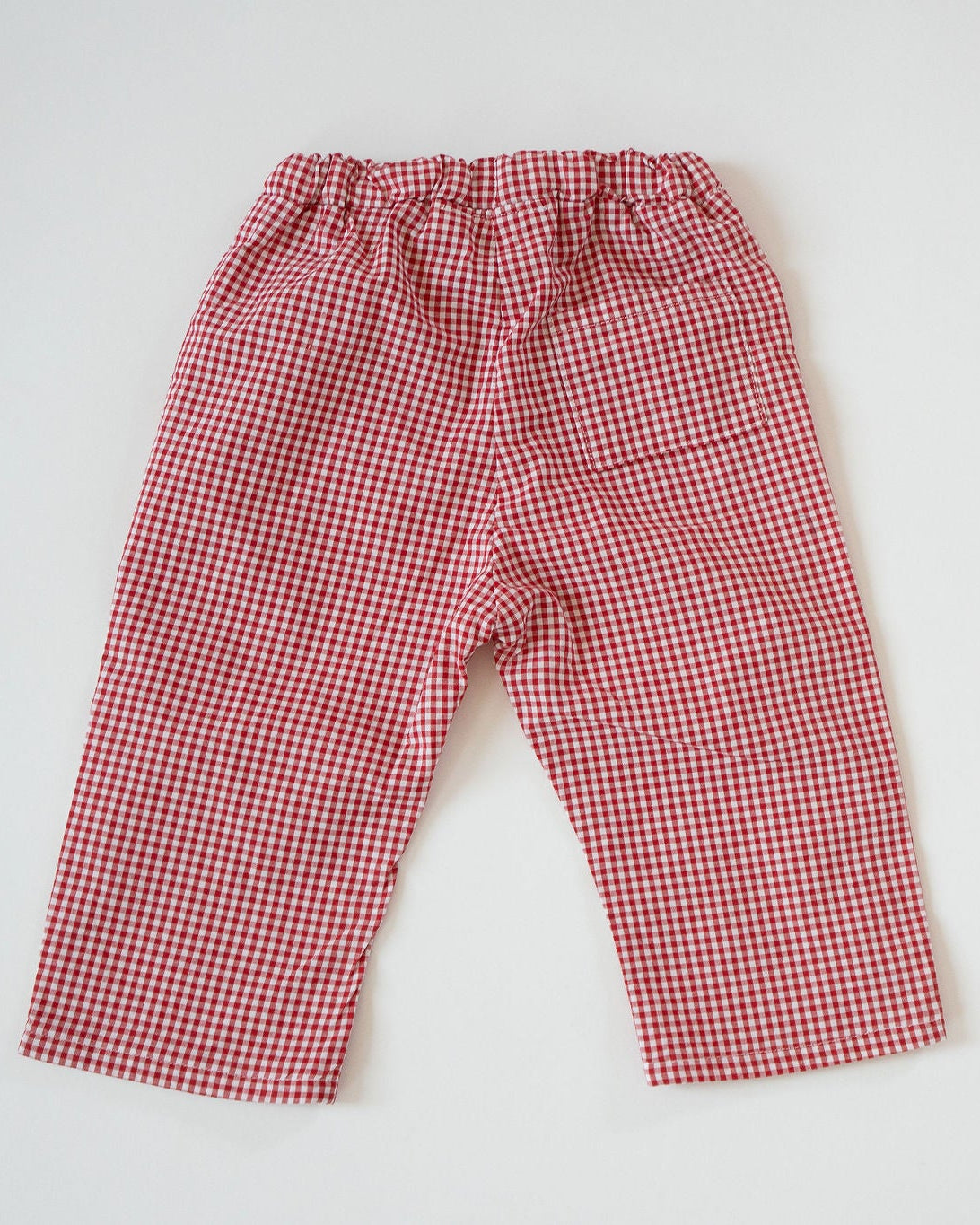 Red and white checkered pants on a light gray background