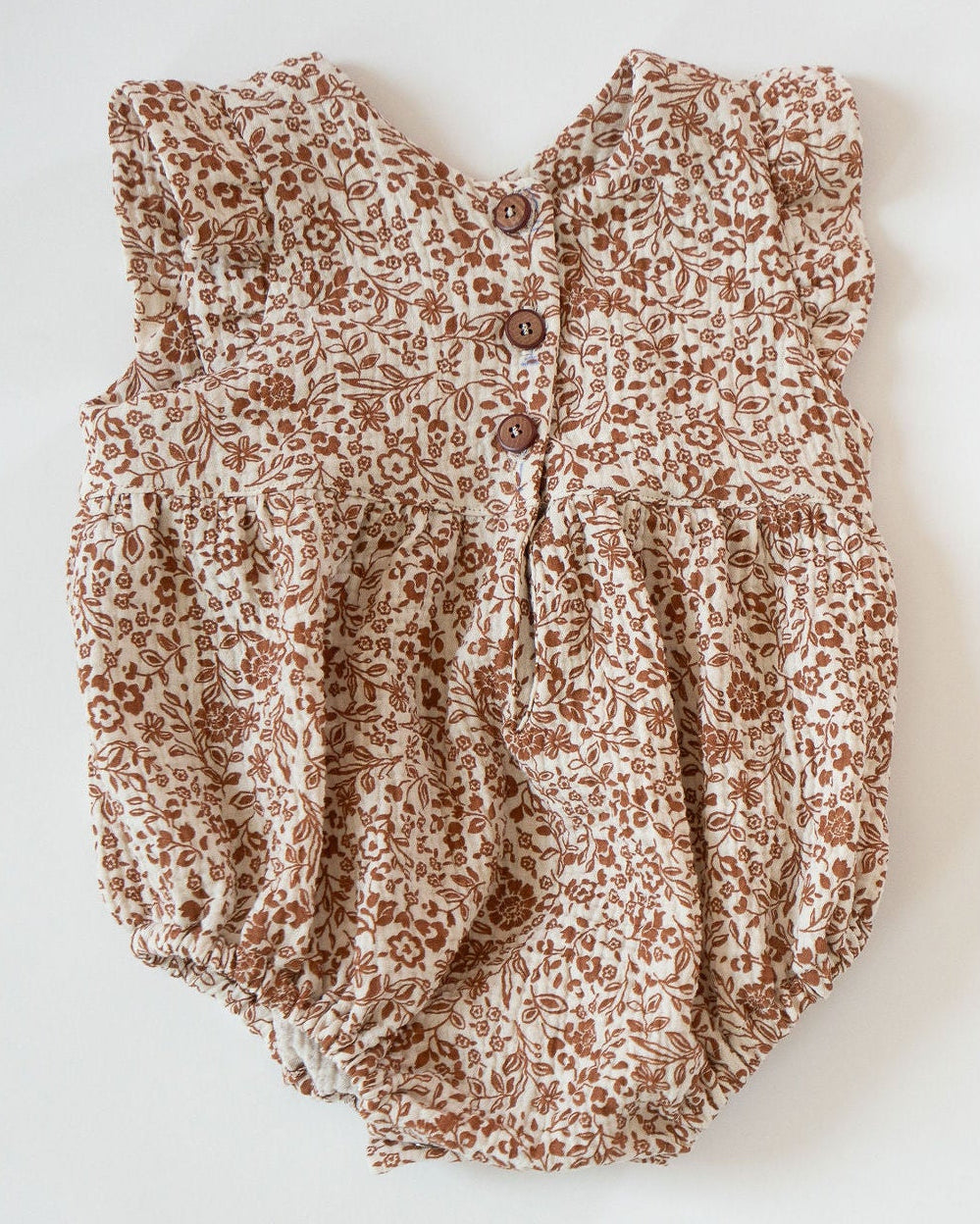 Baby romper with floral pattern on a white background