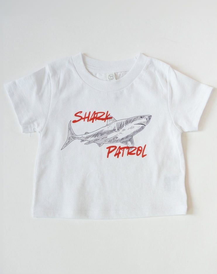 White t-shirt with shark graphic and 'Shark Patrol' text on a white background