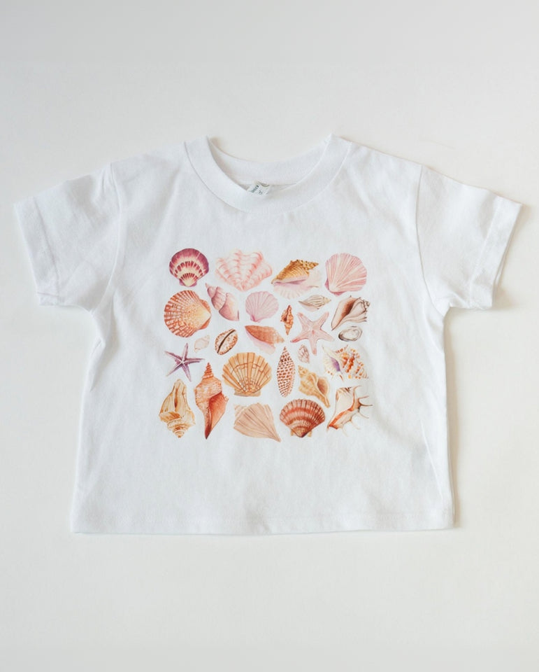 White t-shirt with colorful seashell pattern on a white background