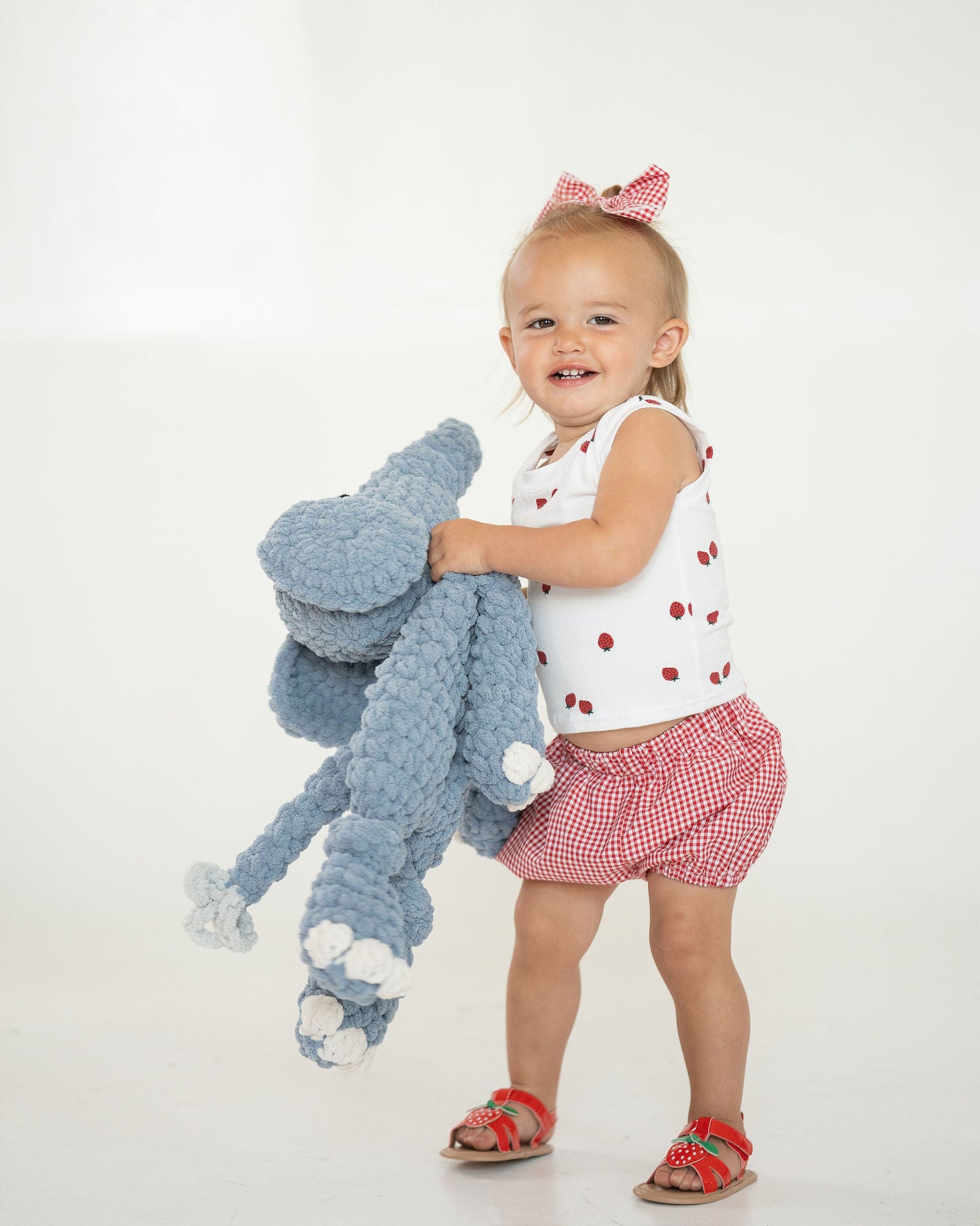 Crocheted blue elephant toy on a white background