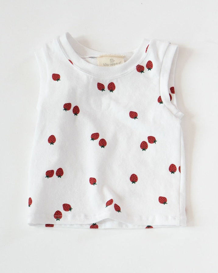 White sleeveless top with red strawberries on a white background
