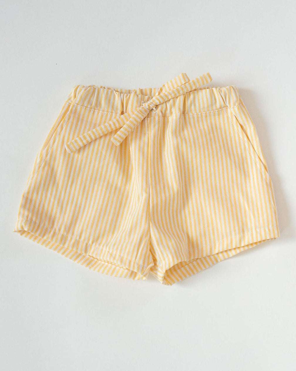 Yellow striped shorts on a light gray background