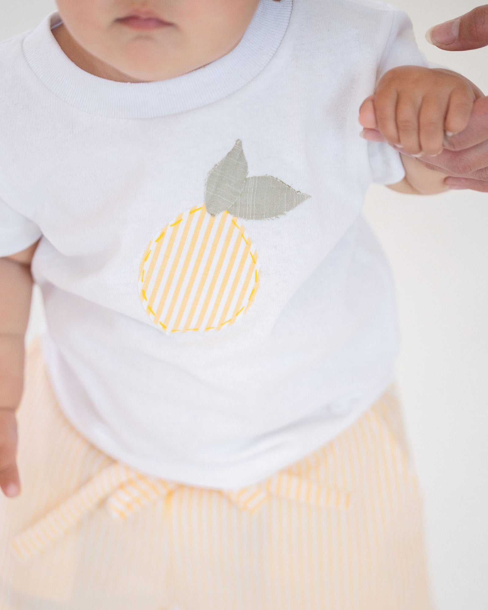 White t-shirt with a lemon design on a white background
