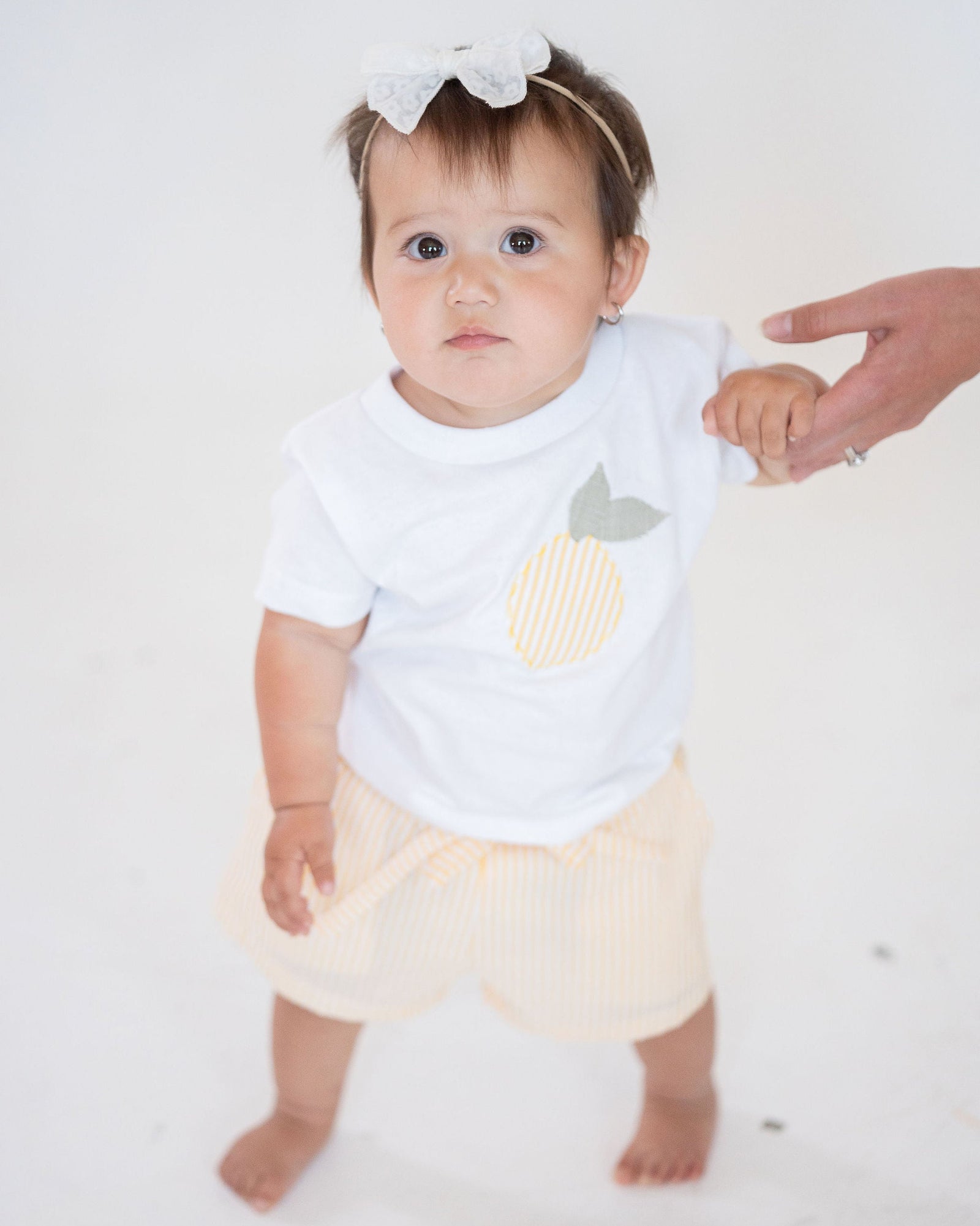 Yellow striped shorts on a light gray background